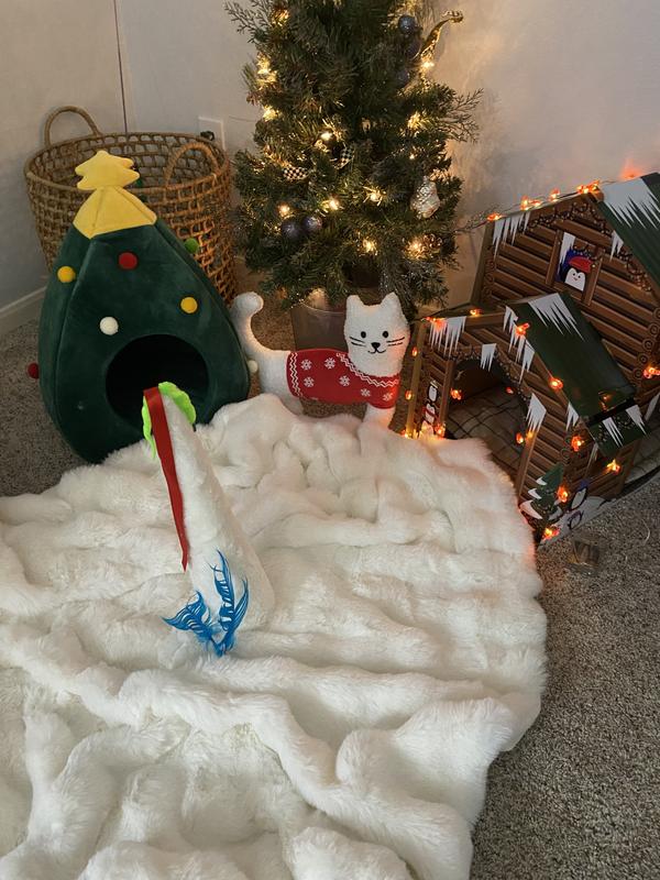 Snow blanket for nap time and a tree with toys hung on it