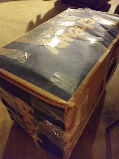 Box has been heavily reinforced with clear shipping tape.