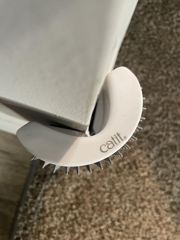 Make sure the brush is placed upright with the label on top “Catit.” Otherwise it won’t stick to the corner correctly.