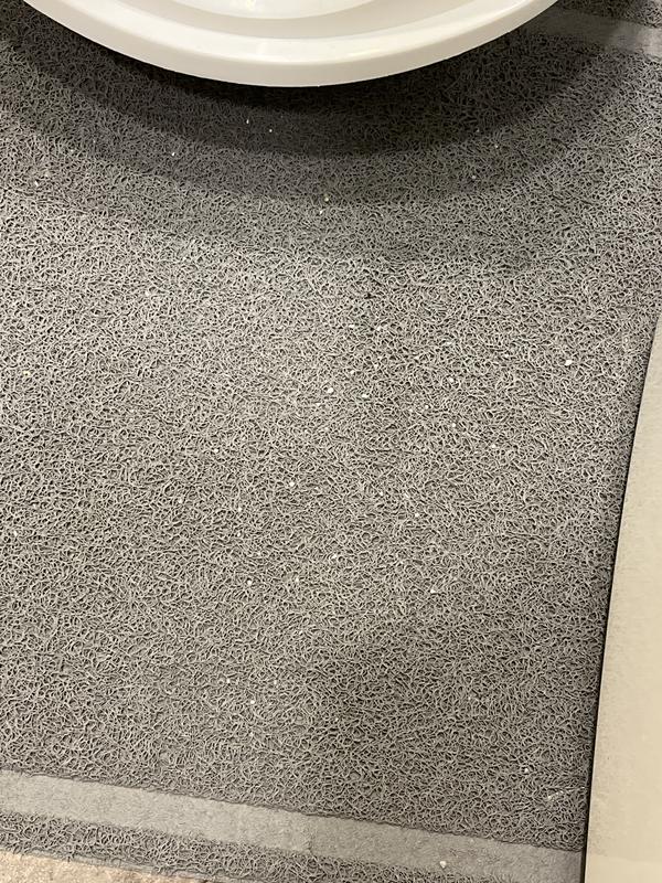 Litter on the mat in front of the box.