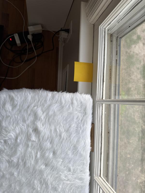 The window sill with a square post-it note for size reference.