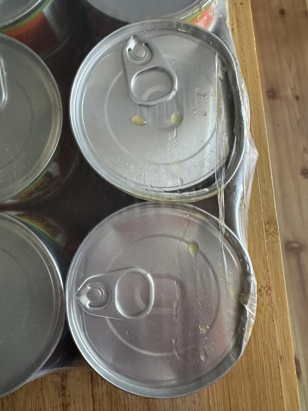 2 cans dented open and leaking fluid.