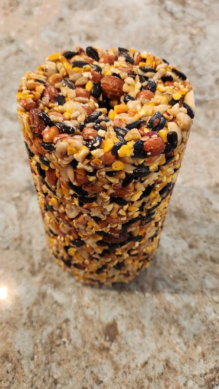 Well-formed log made from a variety of whole nuts, sunflower seeds, and cracked corn