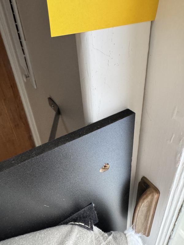 Showing how I had to redrill the existing hole at 45 degree angle so the screw would set in the wood and not through the moulding.