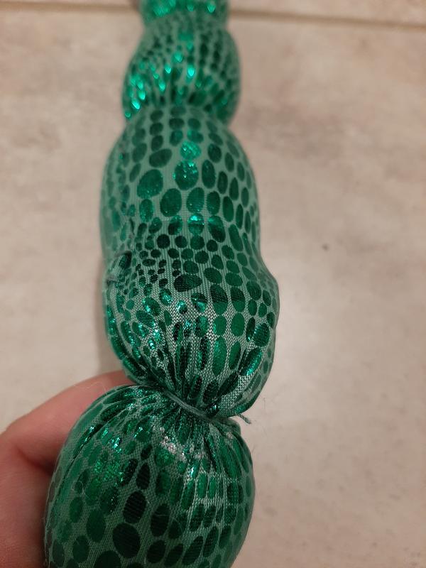 You can see the outer string wrapped around the outside of the toy to create the segment. And then, further back, you can see where one of the outer strings came loose and lost the segment.