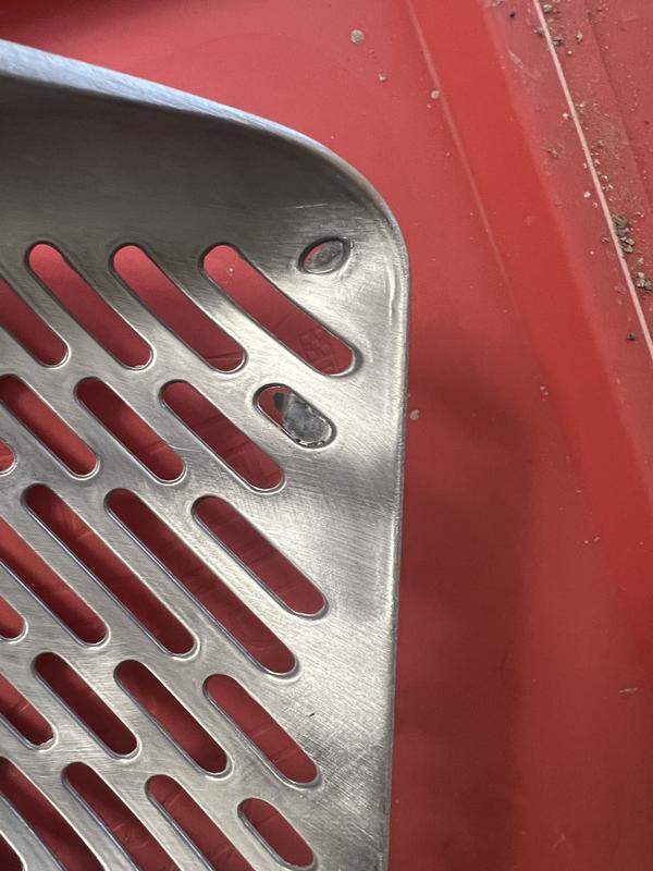 Two holes are not stamped out and degraded properly.