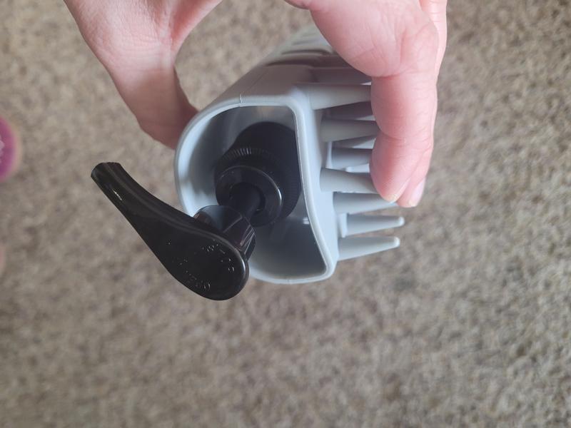 Top view of brush. Bottle is secured in the brush by little stops.