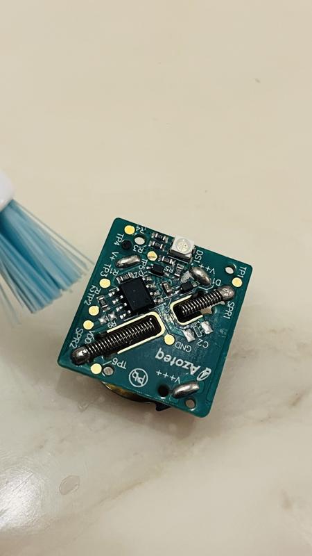 Circuit board with black protective cover off. Spray w alcohol & brush.