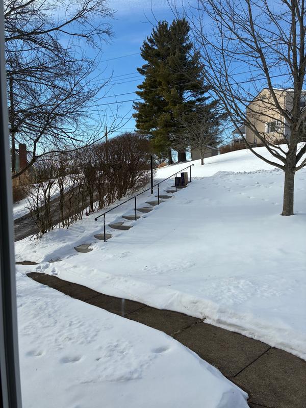 Boxes left far from house on side of the road.