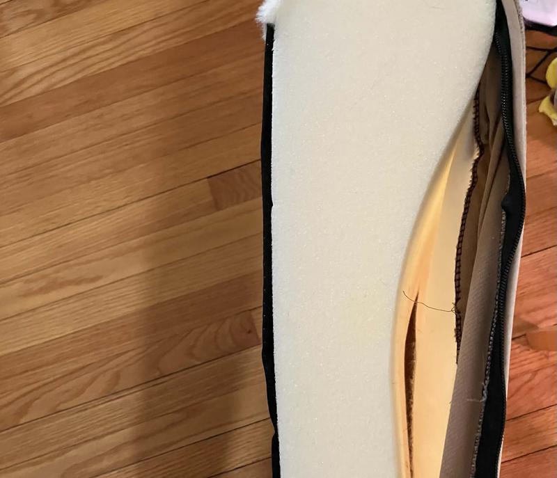 this is supposed to be a picture of the white bed material under the cover. The cover material fits it well.