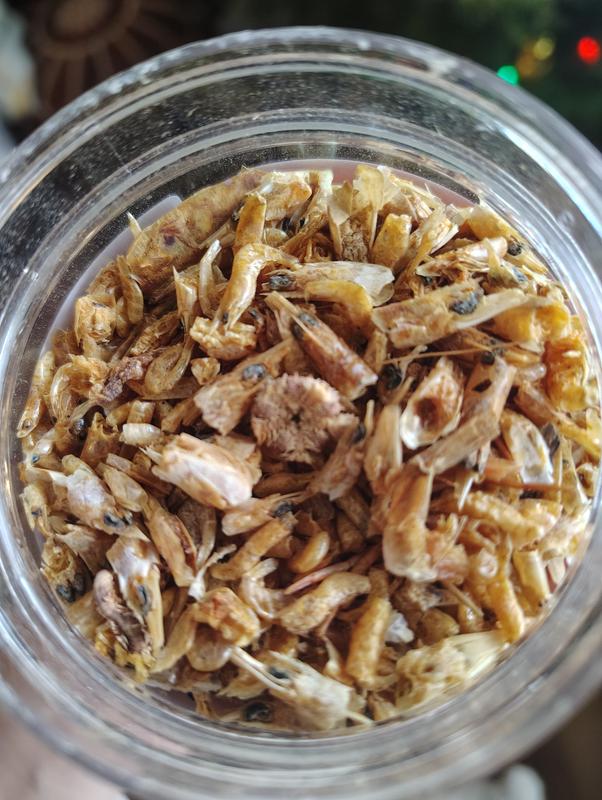 Shaking the container will allow the largest bits to surface on top. Sadly, it's not enough.