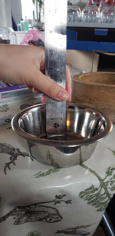 The depth is just a little under 2 inches. probably going to relace it with a more shallow insert