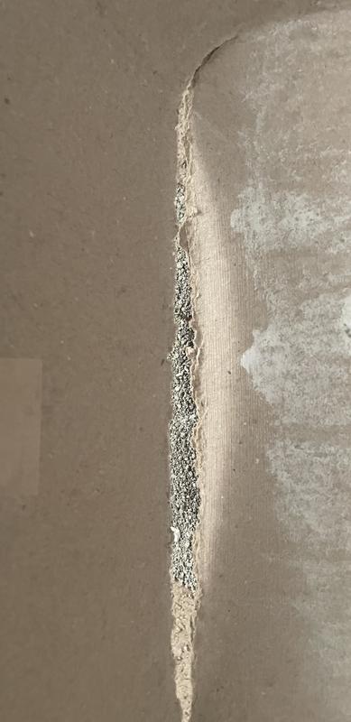 Liquid tore hole in the side of the box.  Note that the carpet is very similar in color to the box.