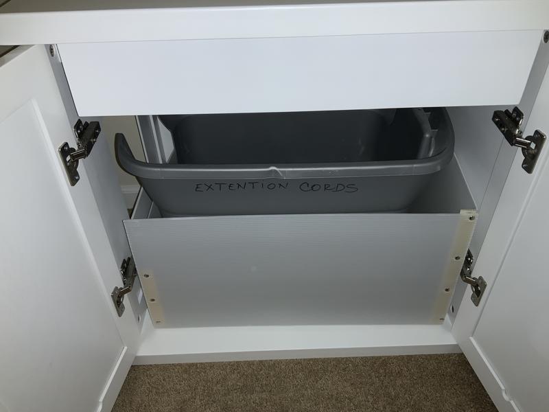 It comes with an inner liner that catches the cat litter as they step out of the tote.  We put felt on the bottom corners and center to prevent it from rubbing the cabinet paint off when sliding it out for scooping.