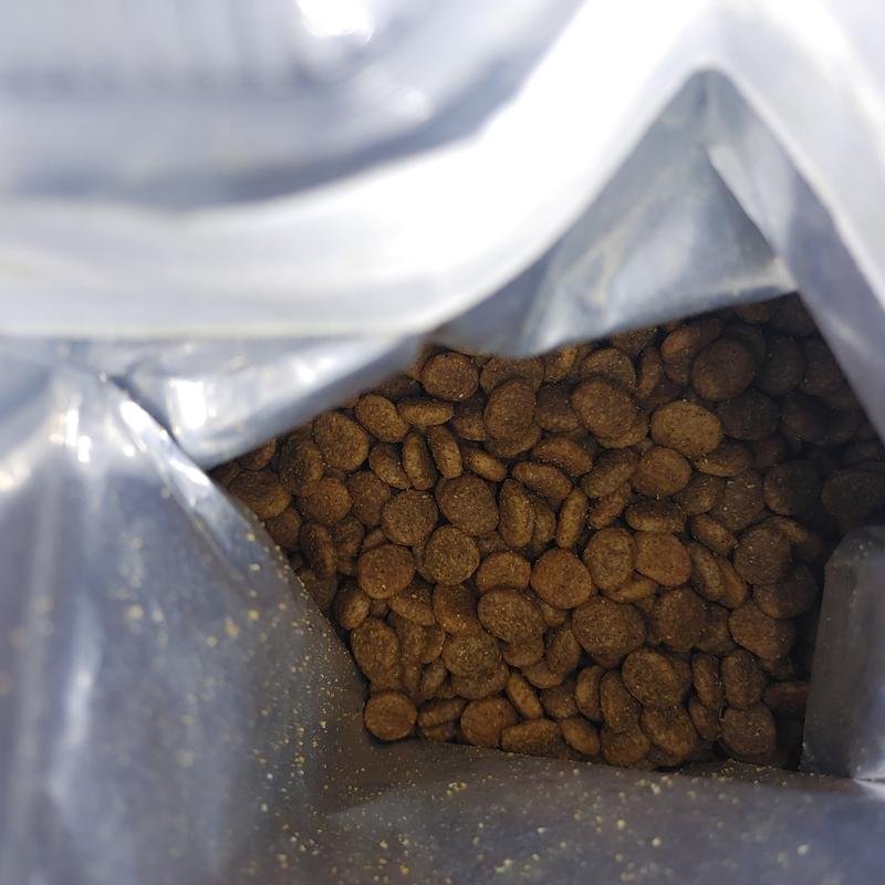 Opening a bag of Bundle x Joy Vibrant Salmon Recipe Dry Dog Food. You will notice that the bag itself has velcro for sealing the bag after opening it. I love that because it really helps keep the kibble stay fresh!