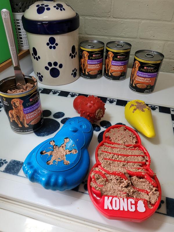 Suffing a variety of freezable toys with Purina canned food.