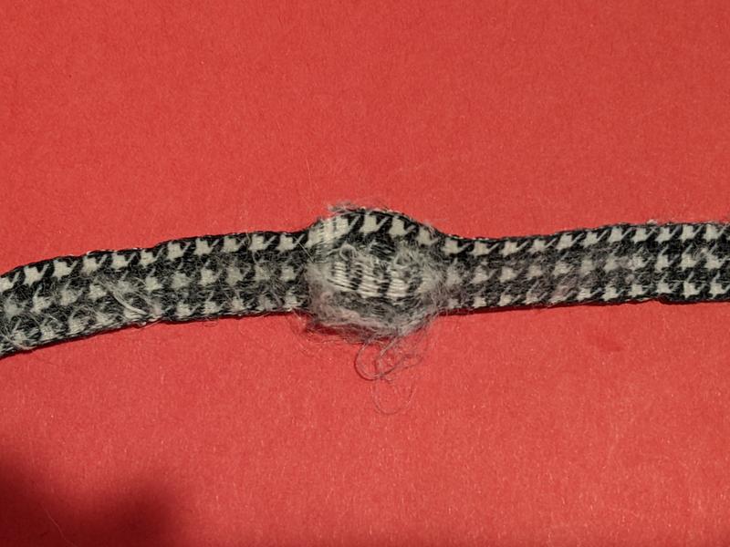 Frayed, with a hole starting