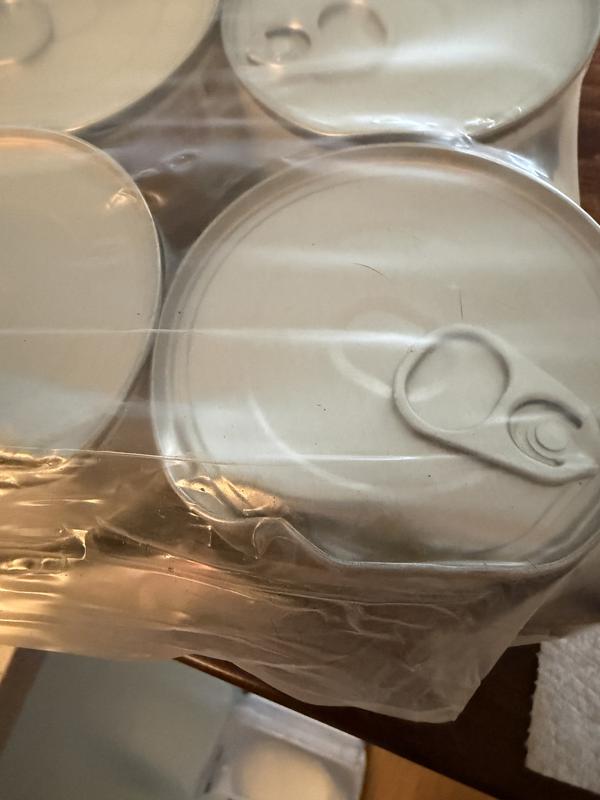 Closer view of another damaged can