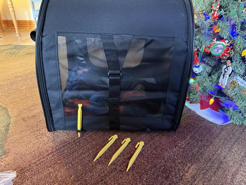 There are little loops to use with the stakes for outside use. This view shows the strap that attaches to the car seat belt.