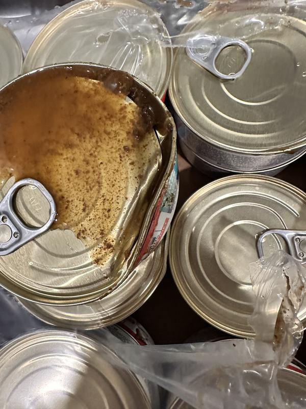 Open and damaged cans with mold present