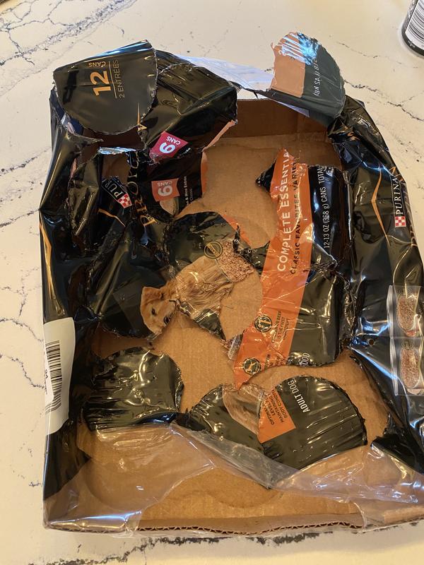 Shredded shrinkwrap, dented cans