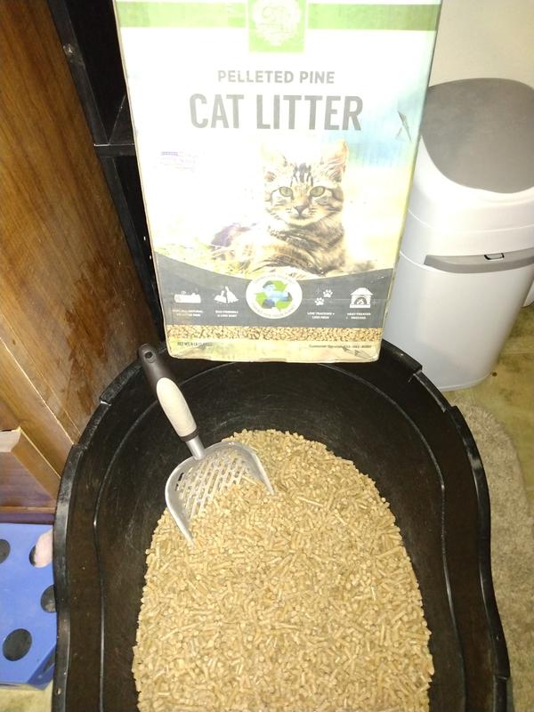 Packaging and product in litter box, with scoop to show pellet size