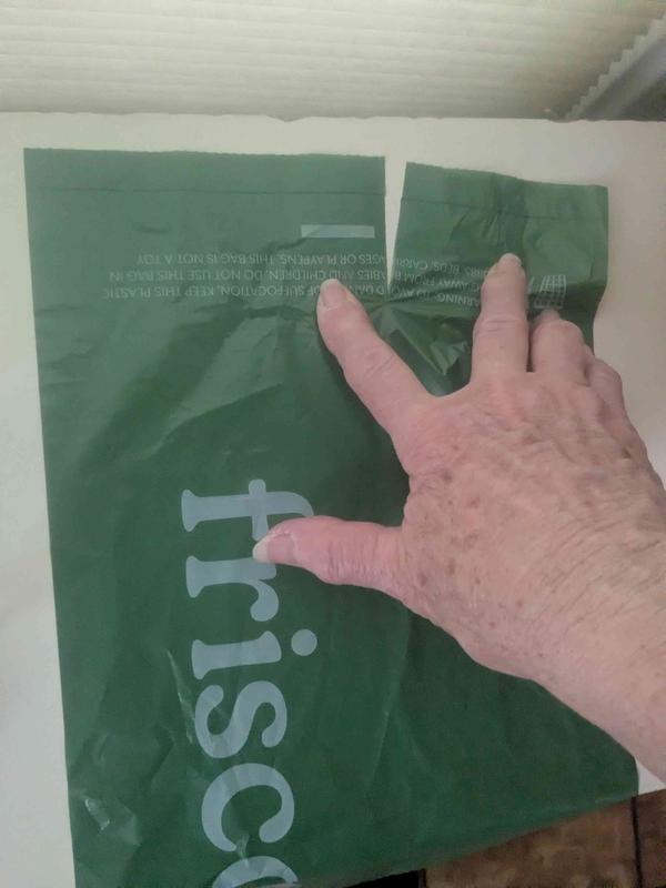 Tear at bottom of poop bag
