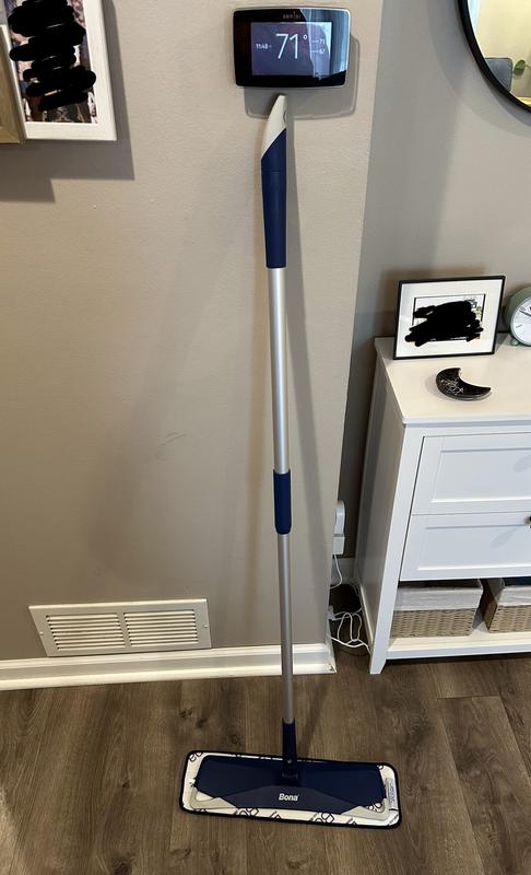 Standing mop with telescoping handle extended.