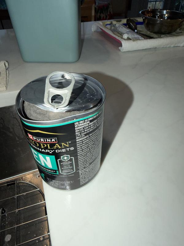 Dented can with lid cracking open spoiling the dog food.