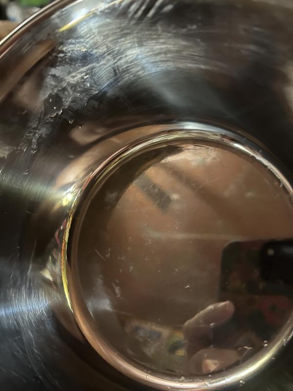 Bits of residue and scratches after razor blade & scouring pad