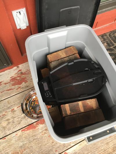 Bricks inside and 15-pound barbell weights on top after the lid is closed.