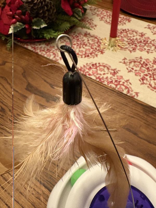 The silver hook that holds the feathers is the part that caught his nail