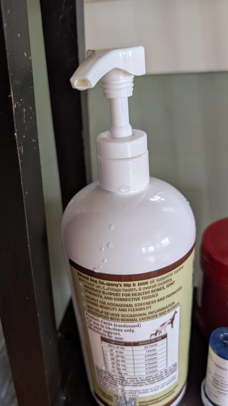 Bottle with oil dripping down from pump
