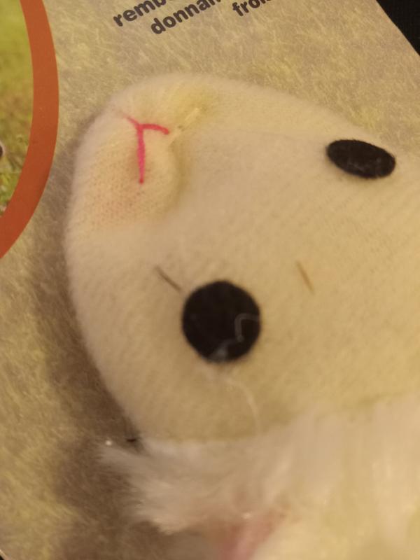 felt eyes with excess glue and loose thread for nose.