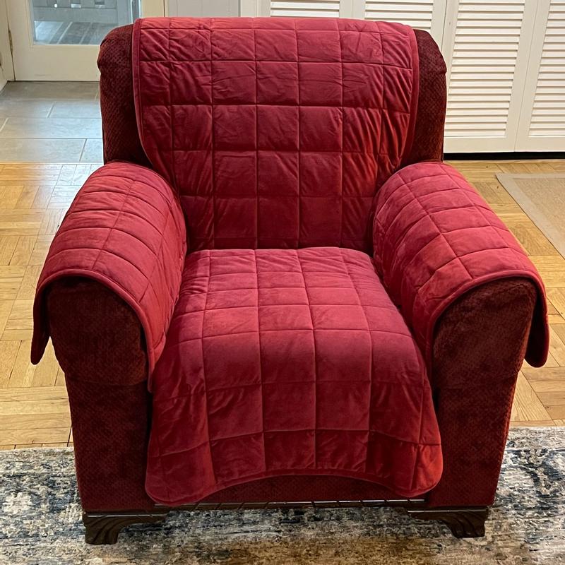 Tucked in around the edges of the seat cushion.