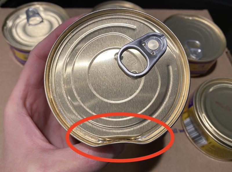 Seal broken on dented can.