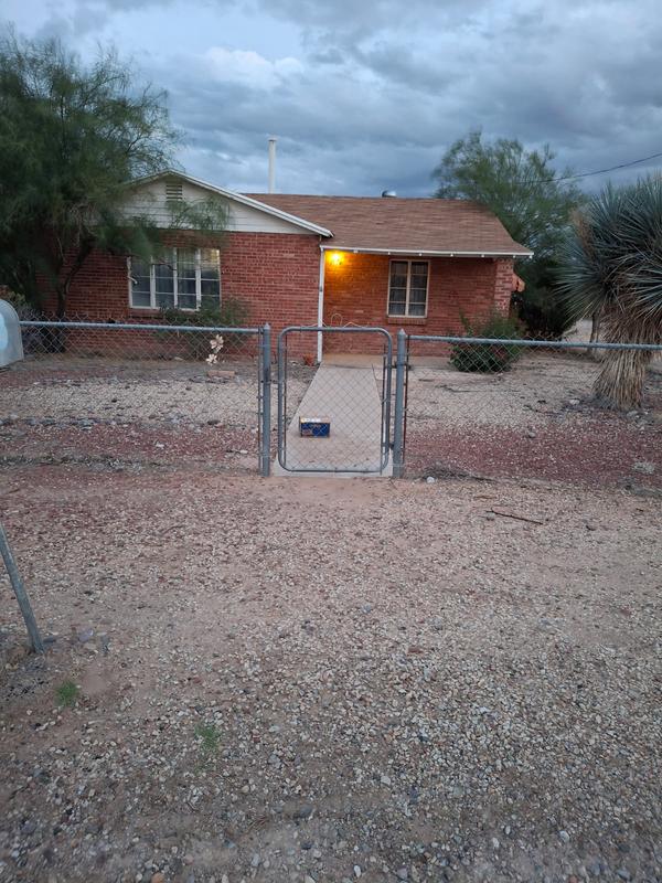 Opening the gate moved the box back to the right. It was simply dropped over the fence of my neighbor's yard.