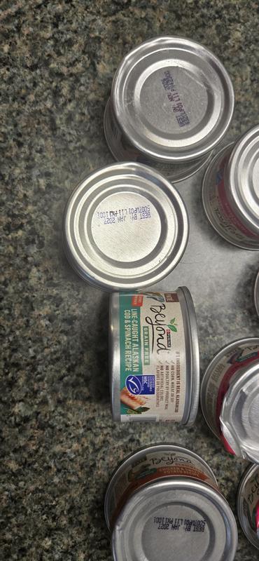 Squash cans and showing you the label of one of them.