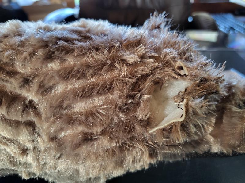 Tear in fabric through to stuffing