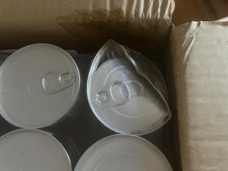 Damaged can in shipping box.