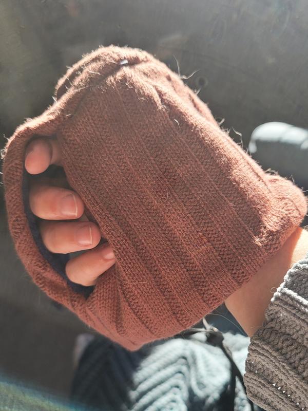 The knit side! Plenty of ear space in the openings I think.