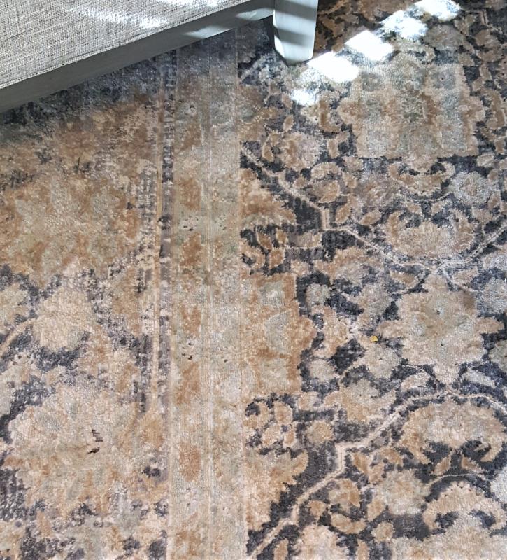 There is a gray-blue in the border that blends well with the chair legs and upholstery.