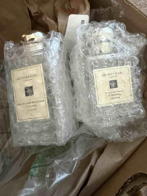 Customer photo for "Perfume smell amazing, but packaging awful"