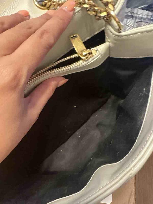 Customer photo for "damaged severely used handbag"
