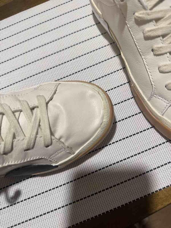 Customer photo for "mismatched sneakers"