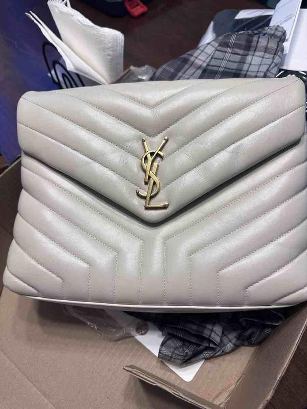Customer photo for "damaged severely used handbag"
