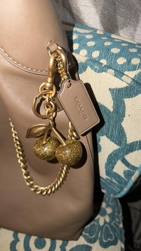 Customer photo for "Coach cherry charm in gold!"