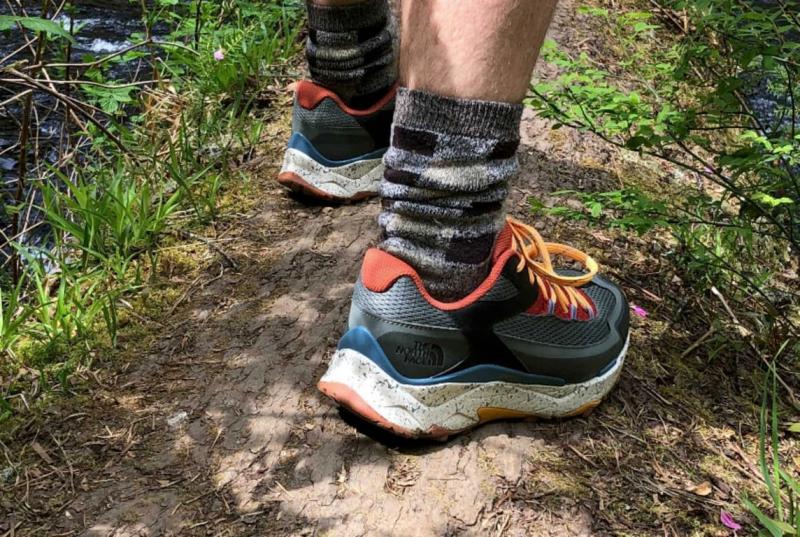 back profile of shoe on fallen tree