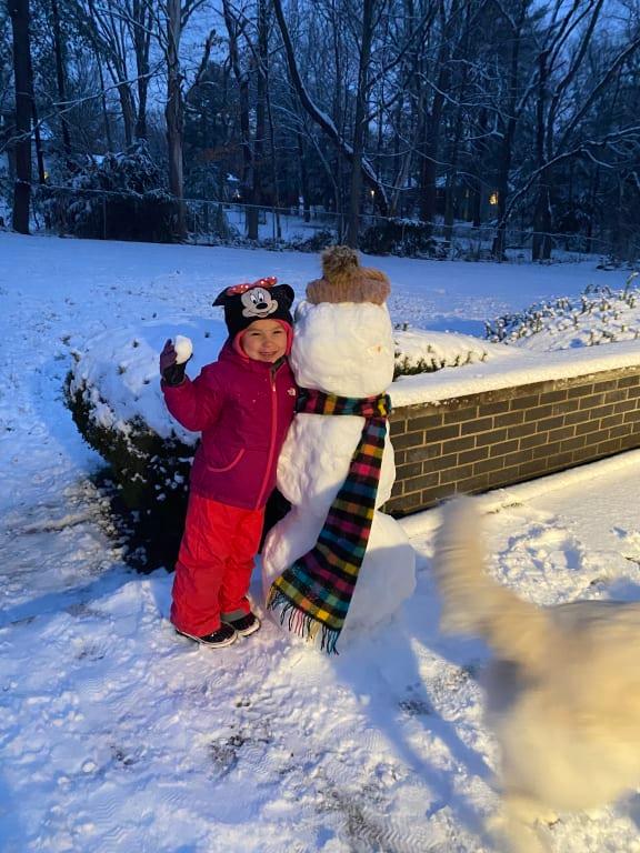 First snowfall building a snowman