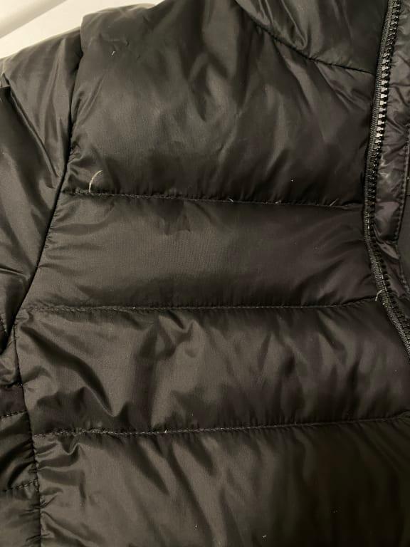 Small Feather's coming out of the seam of the jacket